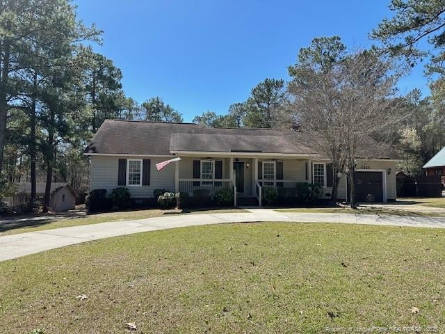 5423 Fisher Rd, Fayetteville, NC 28304 - ranch-style home with an attached garage, a front lawn, driveway, and covered porch