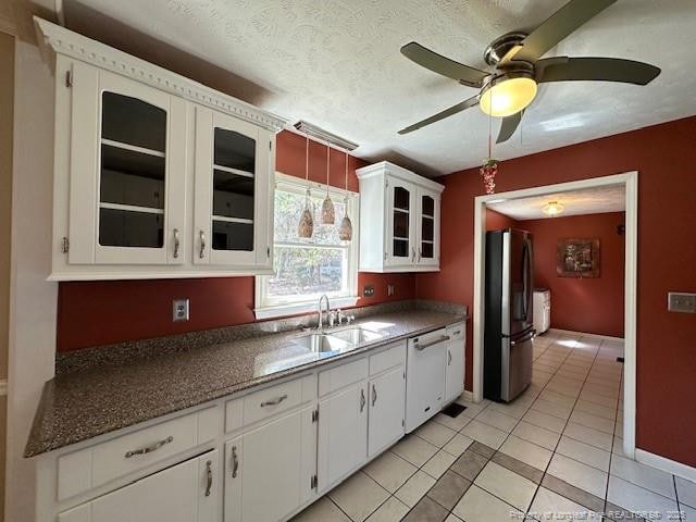 5423 Fisher Rd, Fayetteville, NC 28304 - kitchen featuring ceiling fan, freestanding refrigerator, light tile patterned floors, dishwasher, and a sink