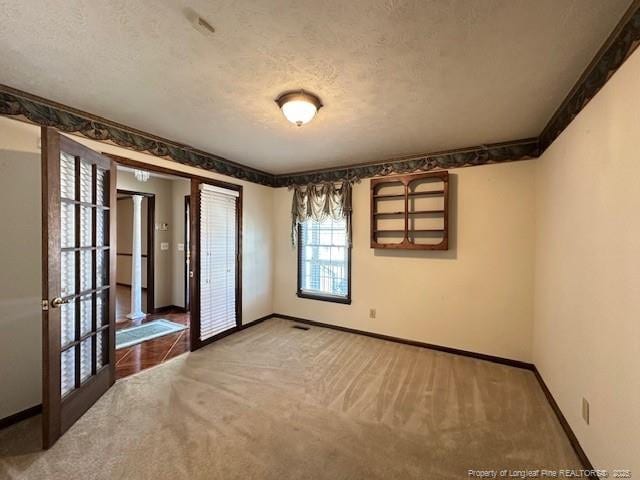 5423 Fisher Rd, Fayetteville, NC 28304 - carpeted empty room with baseboards and a textured ceiling