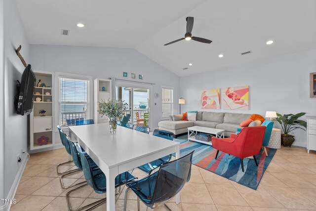 dining room featuring lofted ceiling, visible vents, light tile patterned floors, and ceiling fan