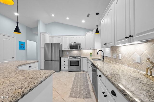kitchen with light stone countertops, white cabinetry, visible vents, a sink, and stainless steel appliances