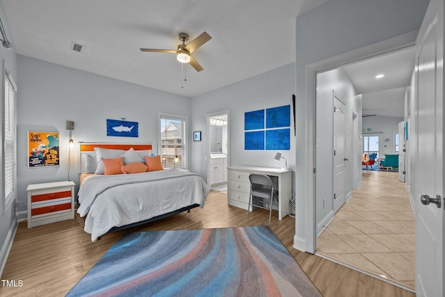 bedroom featuring ceiling fan, connected bathroom, visible vents, light wood finished floors, and baseboards