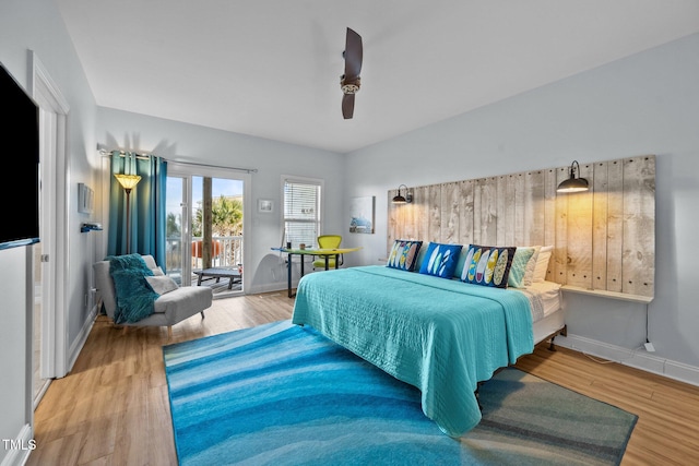 bedroom with access to exterior, wood finished floors, baseboards, and a ceiling fan