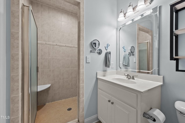 bathroom featuring a shower stall, vanity, and toilet