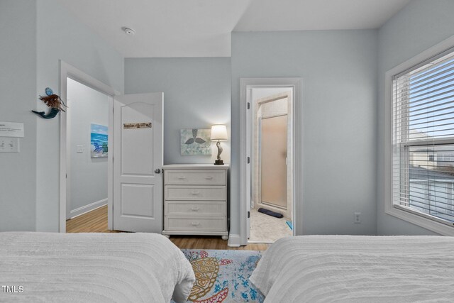 bedroom with baseboards and wood finished floors