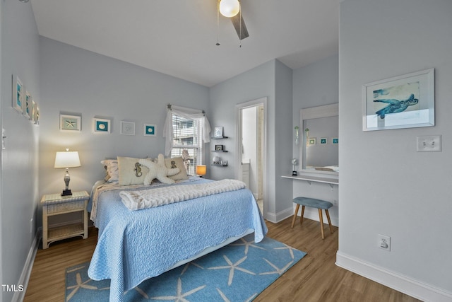 bedroom with ceiling fan, baseboards, and wood finished floors