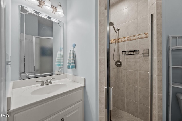full bathroom with a shower stall, vanity, and toilet