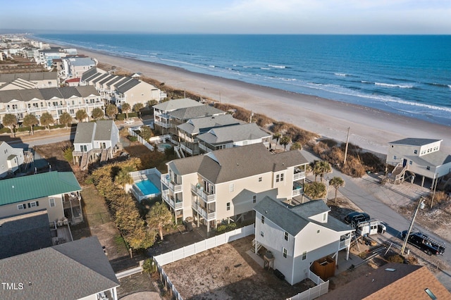 birds eye view of property with a beach view, a residential view, and a water view