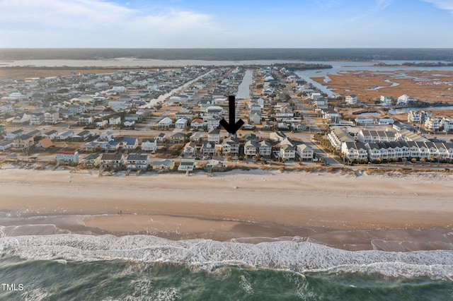 birds eye view of property featuring a view of the beach, a residential view, and a water view