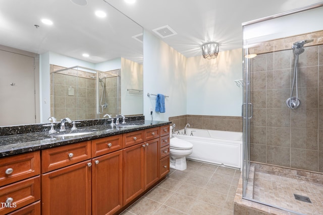 bathroom with a sink, tile patterned floors, a shower stall, and visible vents