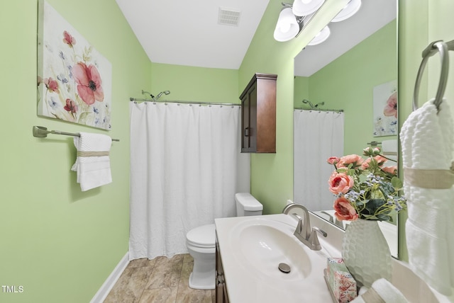bathroom featuring toilet, baseboards, vanity, and curtained shower