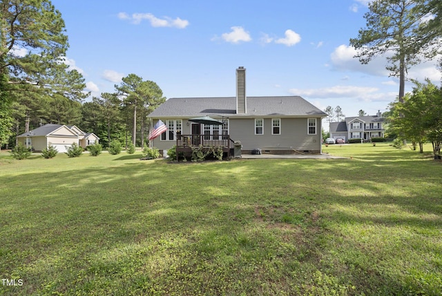 rear view of property featuring a deck, a lawn, a chimney, and crawl space