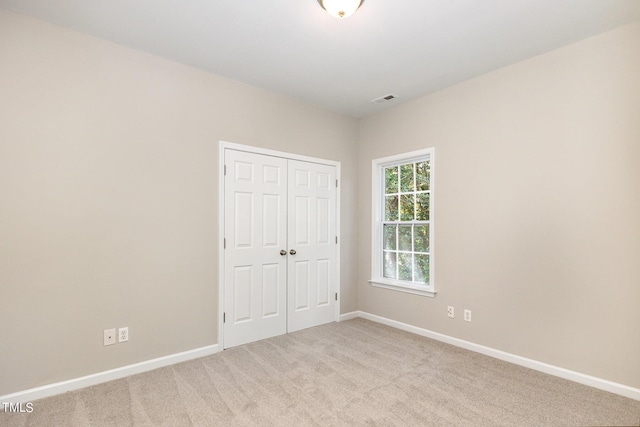 411B Aversboro Rd, Garner, NC 27529 - unfurnished bedroom featuring visible vents, a closet, baseboards, and carpet floors