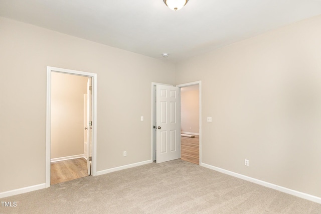 411B Aversboro Rd, Garner, NC 27529 - unfurnished bedroom with baseboards and light colored carpet