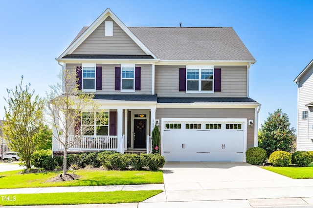 240 Liberty Star Rd, Wendell, NC 27591 - view of front of home with covered porch, concrete driveway, an attached garage, a shingled roof, and a front lawn
