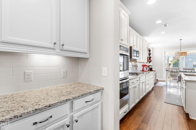 240 Liberty Star Rd, Wendell, NC 27591 - kitchen with appliances with stainless steel finishes, decorative backsplash, white cabinets, dark wood-type flooring, and recessed lighting