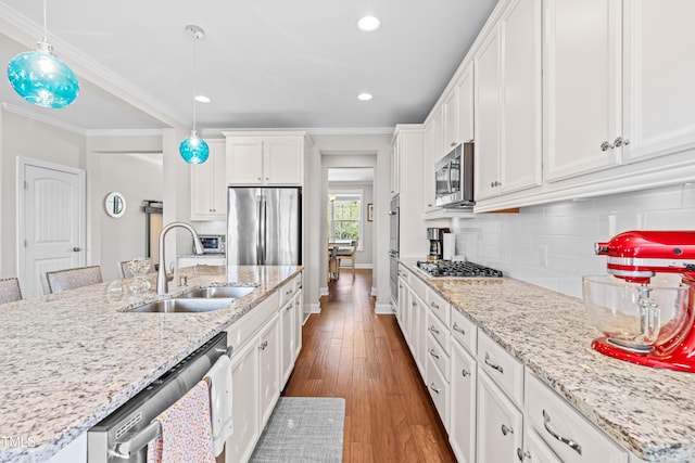 240 Liberty Star Rd, Wendell, NC 27591 - kitchen featuring appliances with stainless steel finishes, a sink, baseboards, white cabinetry, and backsplash