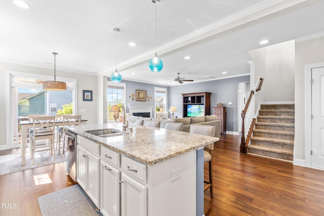 240 Liberty Star Rd, Wendell, NC 27591 - kitchen with a sink, a fireplace, stainless steel dishwasher, ceiling fan, and ornamental molding