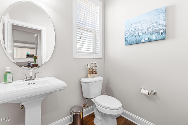 240 Liberty Star Rd, Wendell, NC 27591 - bathroom with toilet, baseboards, wood finished floors, and a sink