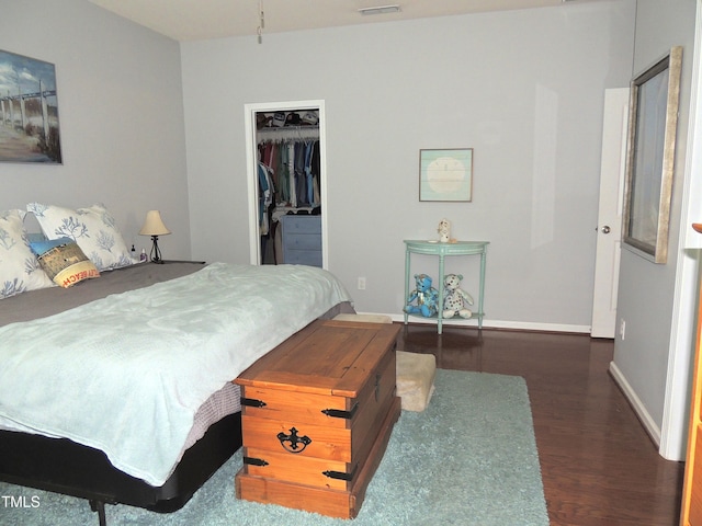 3530 Winding Walk Ct, Raleigh, NC 27616 - bedroom with wood finished floors, a walk in closet, baseboards, and a closet