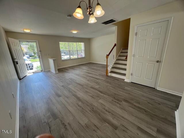 8013 River Water Ct, Raleigh, NC 27616 - unfurnished living room with dark wood-type flooring, baseboards, a notable chandelier, and visible vents