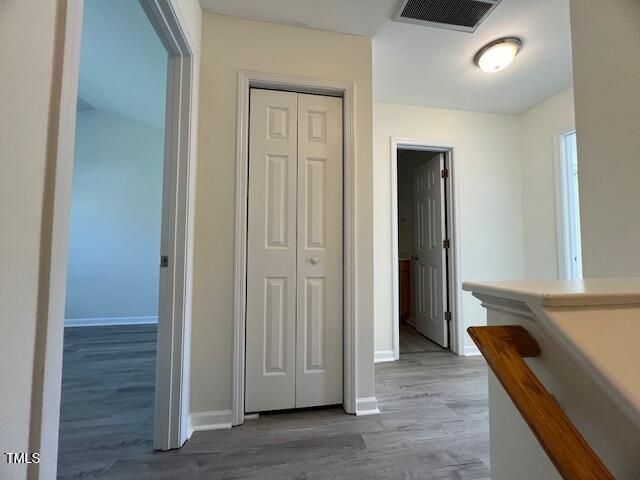 8013 River Water Ct, Raleigh, NC 27616 - corridor with wood finished floors, baseboards, and visible vents