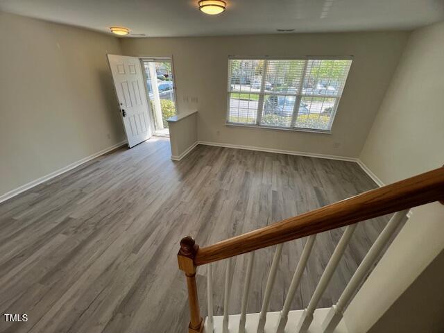 8013 River Water Ct, Raleigh, NC 27616 - interior space with plenty of natural light, baseboards, stairs, and wood finished floors