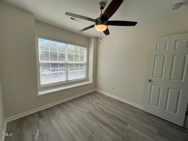 8013 River Water Ct, Raleigh, NC 27616 - unfurnished room featuring wood finished floors, baseboards, a ceiling fan, and visible vents