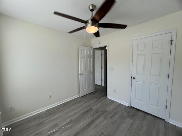 8013 River Water Ct, Raleigh, NC 27616 - unfurnished bedroom with wood finished floors, ceiling fan, and baseboards