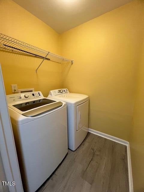 8013 River Water Ct, Raleigh, NC 27616 - laundry area featuring laundry area, wood finished floors, washing machine and clothes dryer, and baseboards