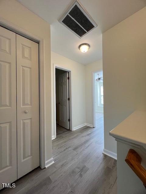 8013 River Water Ct, Raleigh, NC 27616 - hall with dark wood-type flooring, baseboards, and visible vents