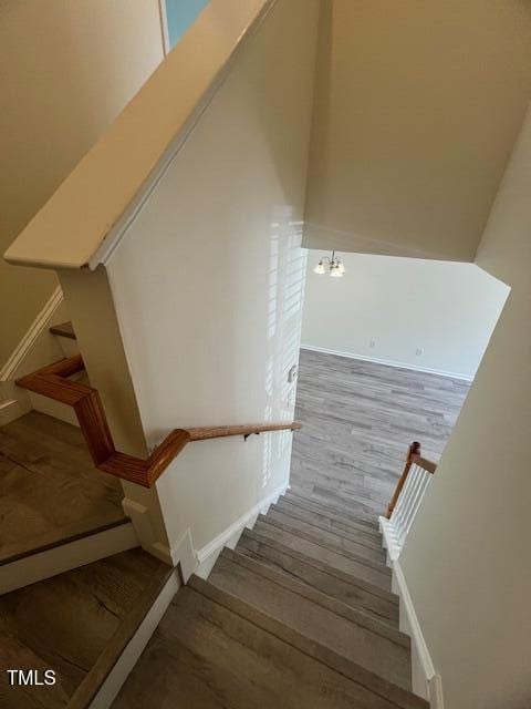 8013 River Water Ct, Raleigh, NC 27616 - stairway featuring baseboards and wood finished floors
