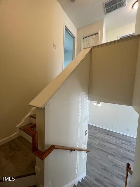 8013 River Water Ct, Raleigh, NC 27616 - stairs with visible vents, baseboards, and wood finished floors