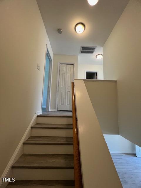 8013 River Water Ct, Raleigh, NC 27616 - staircase with visible vents, baseboards, and wood finished floors