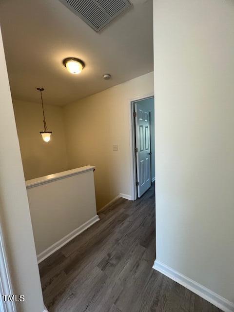 8013 River Water Ct, Raleigh, NC 27616 - corridor with an upstairs landing, dark wood-style flooring, baseboards, and visible vents