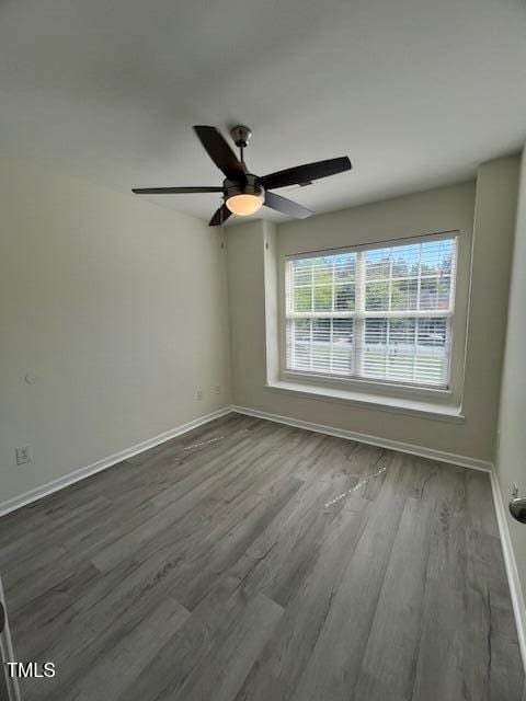 8013 River Water Ct, Raleigh, NC 27616 - spare room featuring dark wood-style flooring, baseboards, and a ceiling fan