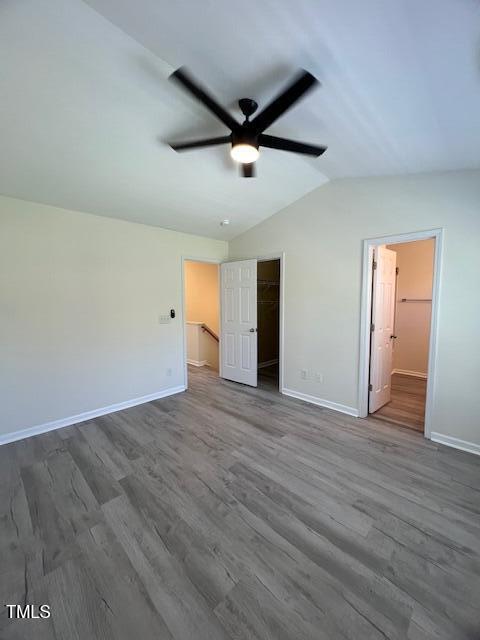 8013 River Water Ct, Raleigh, NC 27616 - unfurnished bedroom with wood finished floors, baseboards, a closet, and lofted ceiling