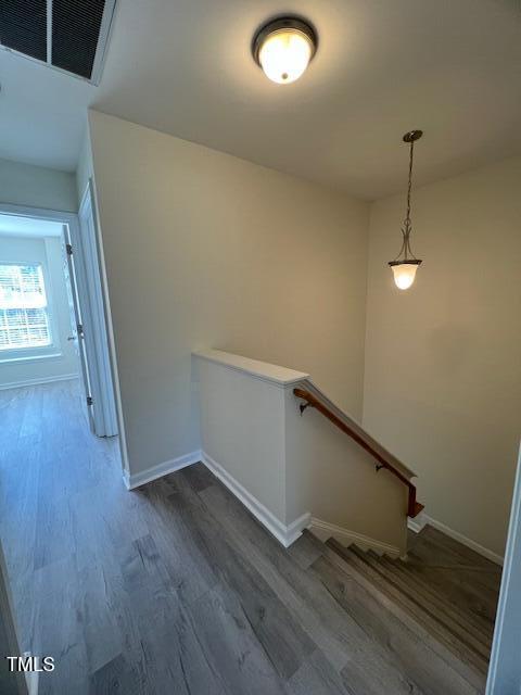 8013 River Water Ct, Raleigh, NC 27616 - staircase with visible vents, baseboards, and wood finished floors