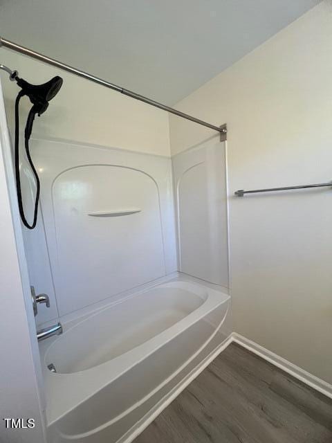 8013 River Water Ct, Raleigh, NC 27616 - bathroom featuring baseboards, bathing tub / shower combination, and wood finished floors