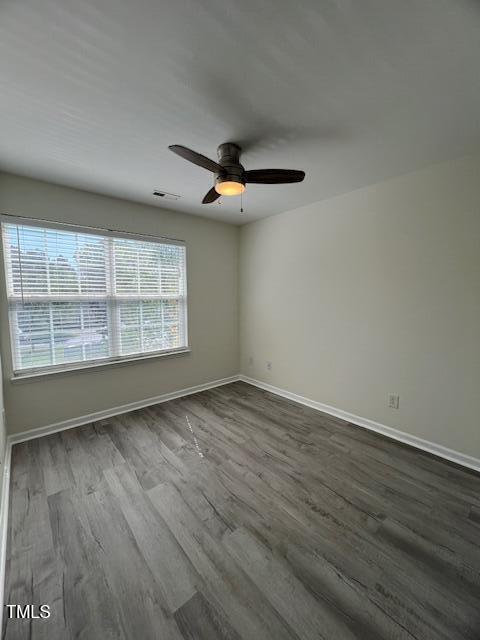 8013 River Water Ct, Raleigh, NC 27616 - spare room with visible vents, ceiling fan, baseboards, and dark wood finished floors