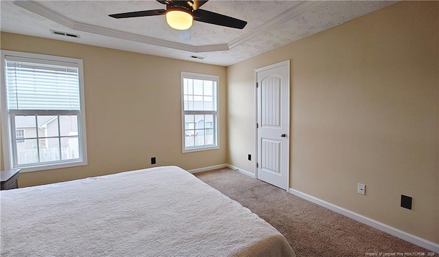 bedroom featuring a raised ceiling, baseboards, carpet, and visible vents