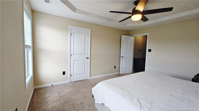carpeted bedroom featuring baseboards, a textured ceiling, and a tray ceiling