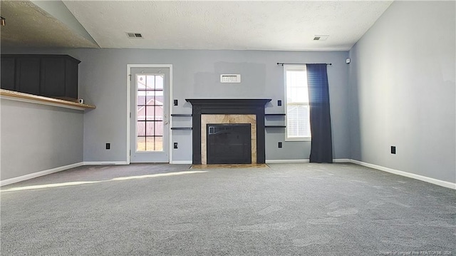 1221 Piping Plover Ct, Fayetteville, NC 28306 - unfurnished living room featuring carpet floors, a high end fireplace, baseboards, and a textured ceiling