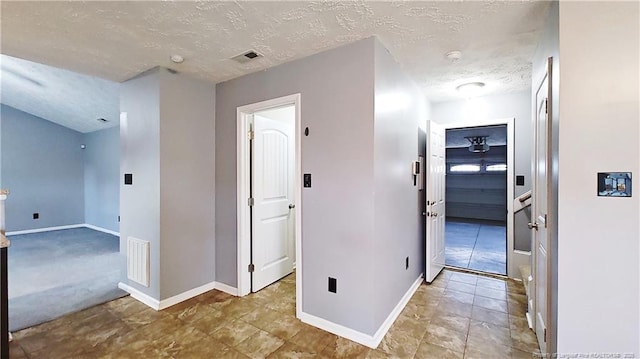 1221 Piping Plover Ct, Fayetteville, NC 28306 - corridor featuring baseboards and a textured ceiling
