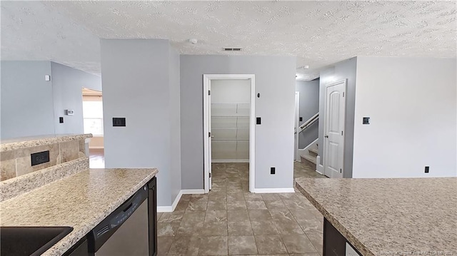 1221 Piping Plover Ct, Fayetteville, NC 28306 - kitchen with a textured ceiling, baseboards, dishwasher, and light countertops