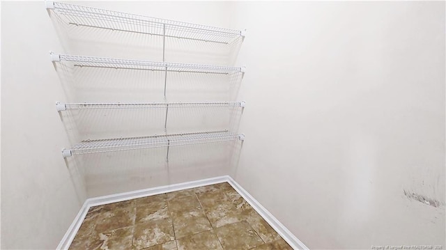 1221 Piping Plover Ct, Fayetteville, NC 28306 - walk in closet featuring stone finish floors