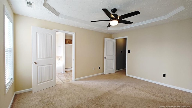 1221 Piping Plover Ct, Fayetteville, NC 28306 - unfurnished bedroom with light carpet, baseboards, a textured ceiling, a tray ceiling, and ceiling fan