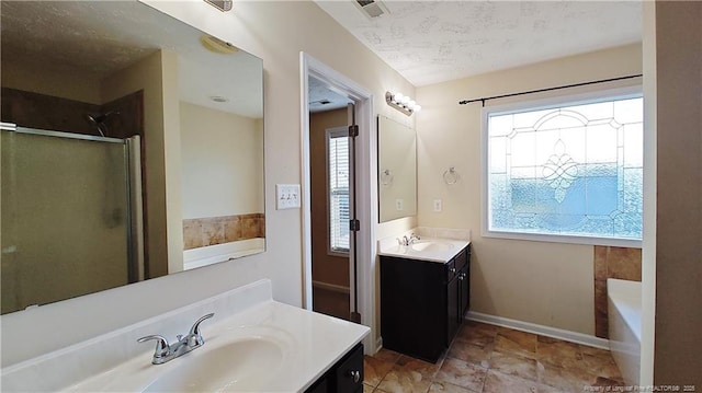 1221 Piping Plover Ct, Fayetteville, NC 28306 - full bath featuring a stall shower, two vanities, a garden tub, and baseboards