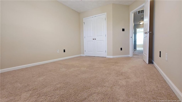 1221 Piping Plover Ct, Fayetteville, NC 28306 - unfurnished bedroom with light carpet, baseboards, and a closet