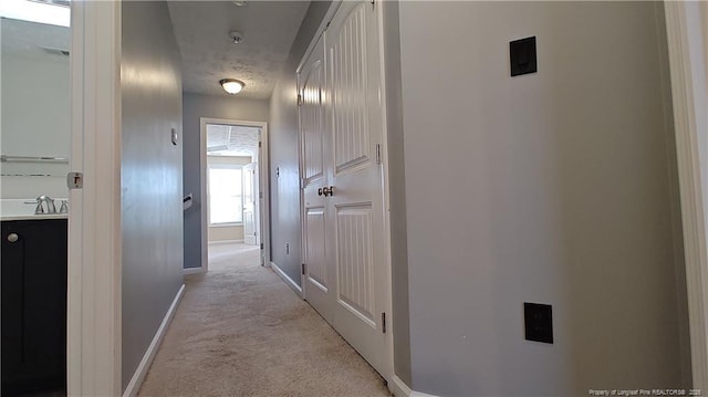 1221 Piping Plover Ct, Fayetteville, NC 28306 - hall featuring baseboards, light colored carpet, and a sink